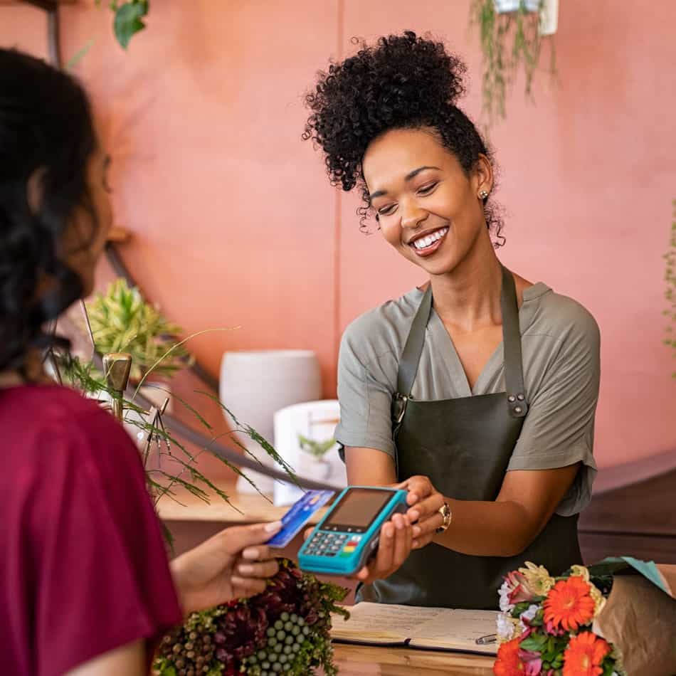 Young woman purchasing flowers.